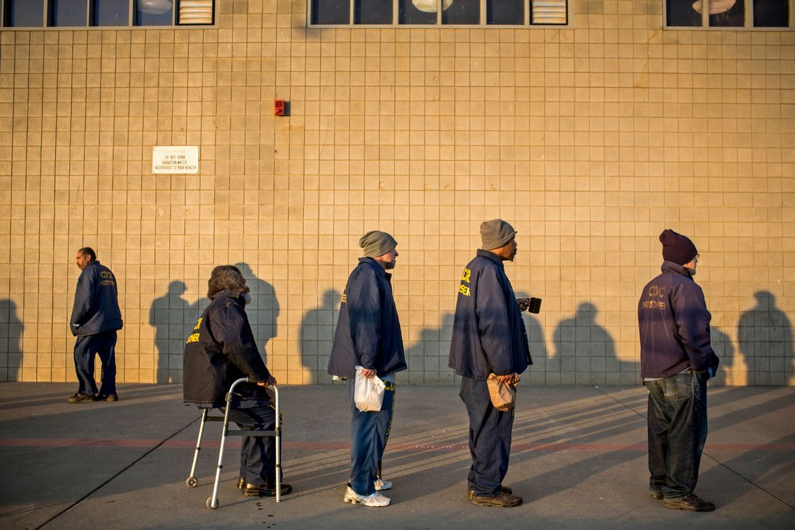 George Whitfield, sitting at left, waits to receive his daily blood pressure medicine at California State Prison, Solano, in Dec. 2013. 