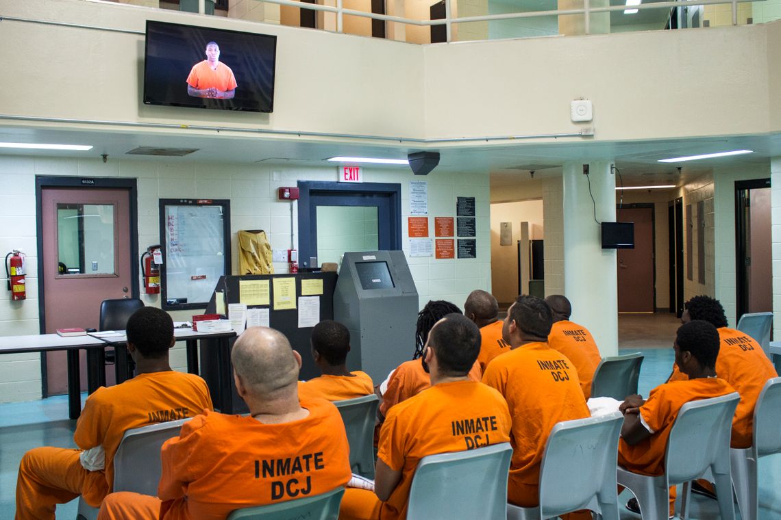 A group of newly arriving inmates are shown a video that describes the jail's policies to detect and prevent sexual assault.