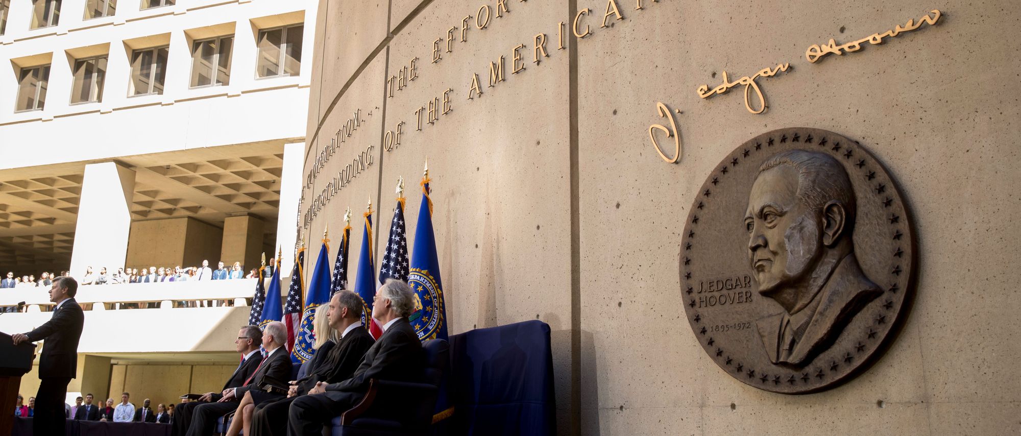 FBI Director Chris Wray, left, speaks at his installation ceremony at the FBI Building, in Washington in September.